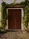 Rustic wooden door, surrounded by climbing rose plants. Alhambra, Granada. Royalty Free Stock Photo