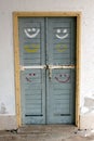 Rustic wooden doors with smileys