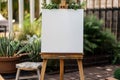 Rustic wooden easel with whiteboard canvas in a garden setting. Royalty Free Stock Photo