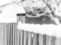 Rustic wooden fence post and country fence covered in deep snow Royalty Free Stock Photo