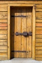 Rustic wooden fortress door with old iron latch Royalty Free Stock Photo