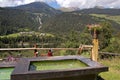 Rustic Wooden Fountain in Swiss Alps - Engadin valley Switzerland Royalty Free Stock Photo