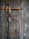 Rustic wooden gate with rusty padlock and latch Royalty Free Stock Photo