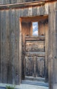 Rustic wooden house door with window Royalty Free Stock Photo