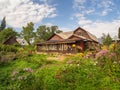 Rustic wooden house with a flower garden. Old wooden house Royalty Free Stock Photo