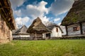 Rustic wooden houses with thatched roofs