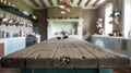 Rustic Wooden Table Stands in Bright Kitchen With Copper Pots Hanging Nearby Royalty Free Stock Photo