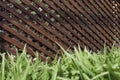 Rustic wooden latticework in the shape of a corridor on a stone floor and green grass Royalty Free Stock Photo