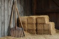 A rustic wooden rake leaning against a stack of fresh hay bales Royalty Free Stock Photo