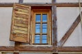 Rustic wooden shutter on vintage timber-framed house wall Royalty Free Stock Photo