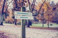 Rustic wooden sign in an autumn park with the words Professional Royalty Free Stock Photo