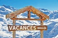 Rustic wooden sign vacances, snowy mountain background