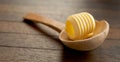 Rustic wooden spoon with butter curl Royalty Free Stock Photo