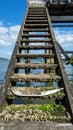 Rustic Wooden Stairs Descend into Ocean Waters with Barnacles and Weathered Texture Royalty Free Stock Photo