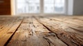 Rustic wooden surface with natural grain patterns and weathered texture in a bright room with blurred large windows in the Royalty Free Stock Photo
