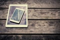 Rustic wooden table with digital tablet and smartphone. View from above