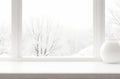 Rustic Wooden Table Framed by Snowy Forest View: Tranquil Window Scene.