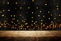 rustic wooden table in front of glitter black and gold bokeh lights. Royalty Free Stock Photo