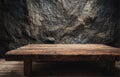 Rustic Wooden Table on Dark Stone Wall Background Royalty Free Stock Photo