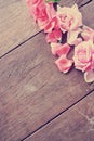 Rustic wooden table with pink roses and rose petals Royalty Free Stock Photo