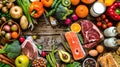 a rustic wooden table, showcasing a colorful arrangement of meat, fish, vegetables, fruits, and milk from an aerial