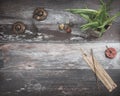 Rustic wooden table with green plant, burning incense, small energy healing stones and Tibetan meditation prayer bells Royalty Free Stock Photo
