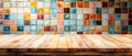 Rustic Wooden Tabletop Against a Vibrant Tiled Kitchen Wall A Blend of Warmth and Color in Interior Design Royalty Free Stock Photo