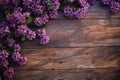 Rustic wooden texture complemented by a vibrant lilac flower arrangement.