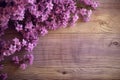 Rustic wooden texture complemented by a vibrant lilac flower arrangement.