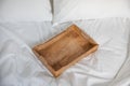 Rustic wooden tray on a white bed. Romantic breakfast in a bed