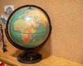 Rustic world globe displaying Africa and Europe in a child`s room Royalty Free Stock Photo