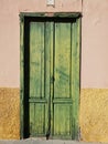 Rustic yellow country house with an old green door in Puerto de la Cruz in Tenerife
