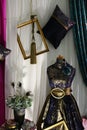 Rustical satin curtains, gold painted wooden frames and headless figurine in luxurious historical woman robe