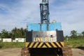 Rusting Antique Blue Crane with Blue Sky