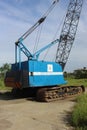 Rusting Antique Blue Crane with Blue Sky