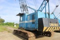 Rusting Antique Blue Crane with Blue Sky