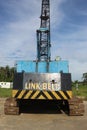 Rusting Antique Blue Crane with Blue Sky