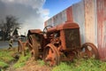 Rusting Fordson tractor and corrugated iron fence