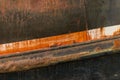 Rusting hull and peeling paint on an old deep sea fishing trawler