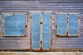 Rusting metal shutters on old wooden cafe.