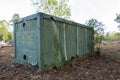 Rusting Old Green Storage Container In Backyard