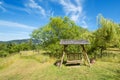 Rusting swing bench in a lush garden Royalty Free Stock Photo