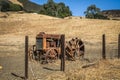 Rusting Tractor in old field of hay and fence Royalty Free Stock Photo