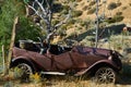 Rusting vehicles in a rural Nevada junk yard