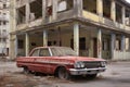 rusting vintage car parked in front of a dilapidated building Royalty Free Stock Photo