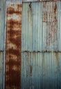 Rusting weathered corrugated iron wall ideal as background