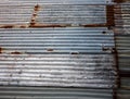 Rusting weathered corrugated iron wall ideal as industrial background