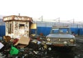 Rusty abandoned car on recycling yard. Scrap metal Recycling industry. Waste separation Business. Rusty stall, gas bottle and Royalty Free Stock Photo