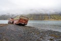 Rusty and abandoned old ship wreck from world war two laying on land in Mjoifjordur in Iceland.