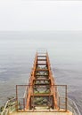 Rusty abandoned pier in sea